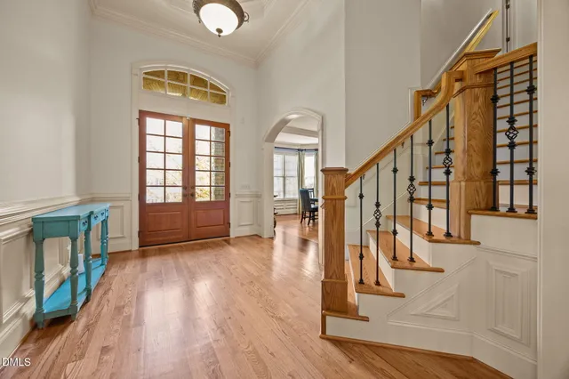 a kitchen with stainless steel appliances kitchen island wooden floors granite counter tops and a window