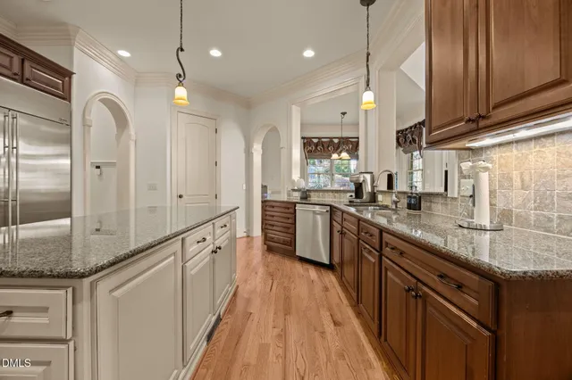 a bathroom with a granite countertop bathtub a sink and a large mirror