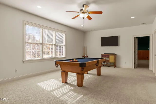 a view of a livingroom with workspace and a window