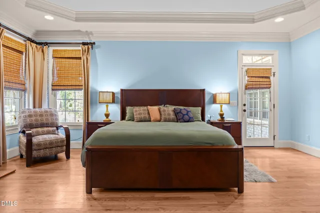 a living room with furniture a fireplace and a chandelier