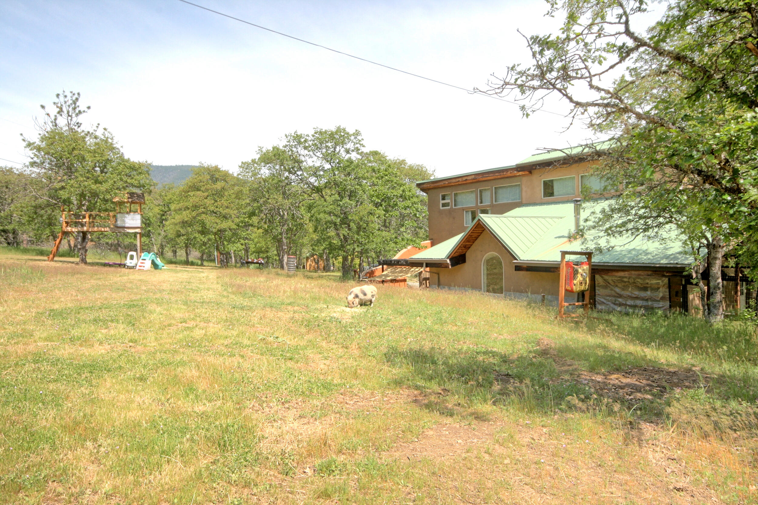 8150 Upper Applegate Road Jacksonville, OR 97530 - Photo 101 of 122 a view of a house with a yard and sitting area