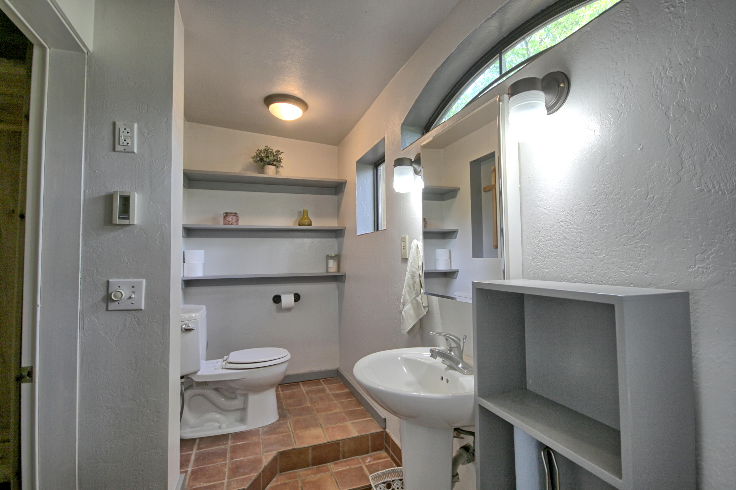 8150 Upper Applegate Road Jacksonville, OR 97530 - Photo 51 of 122 a bathroom with a toilet a sink and mirror