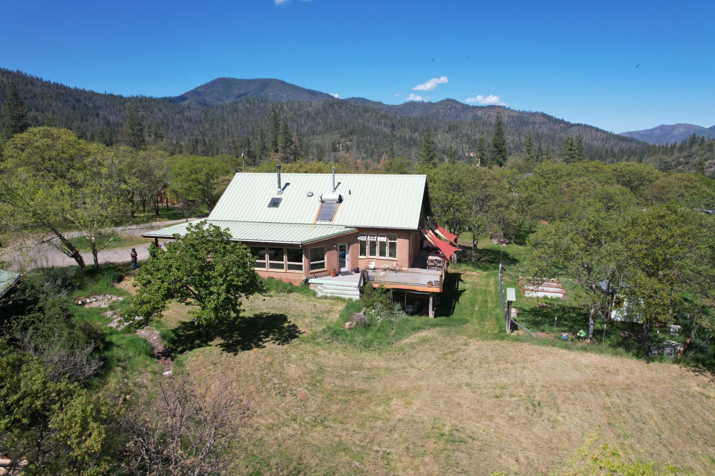 8150 Upper Applegate Road Jacksonville, OR 97530 - Photo 62 of 122 a view of a house with a yard and a sitting area