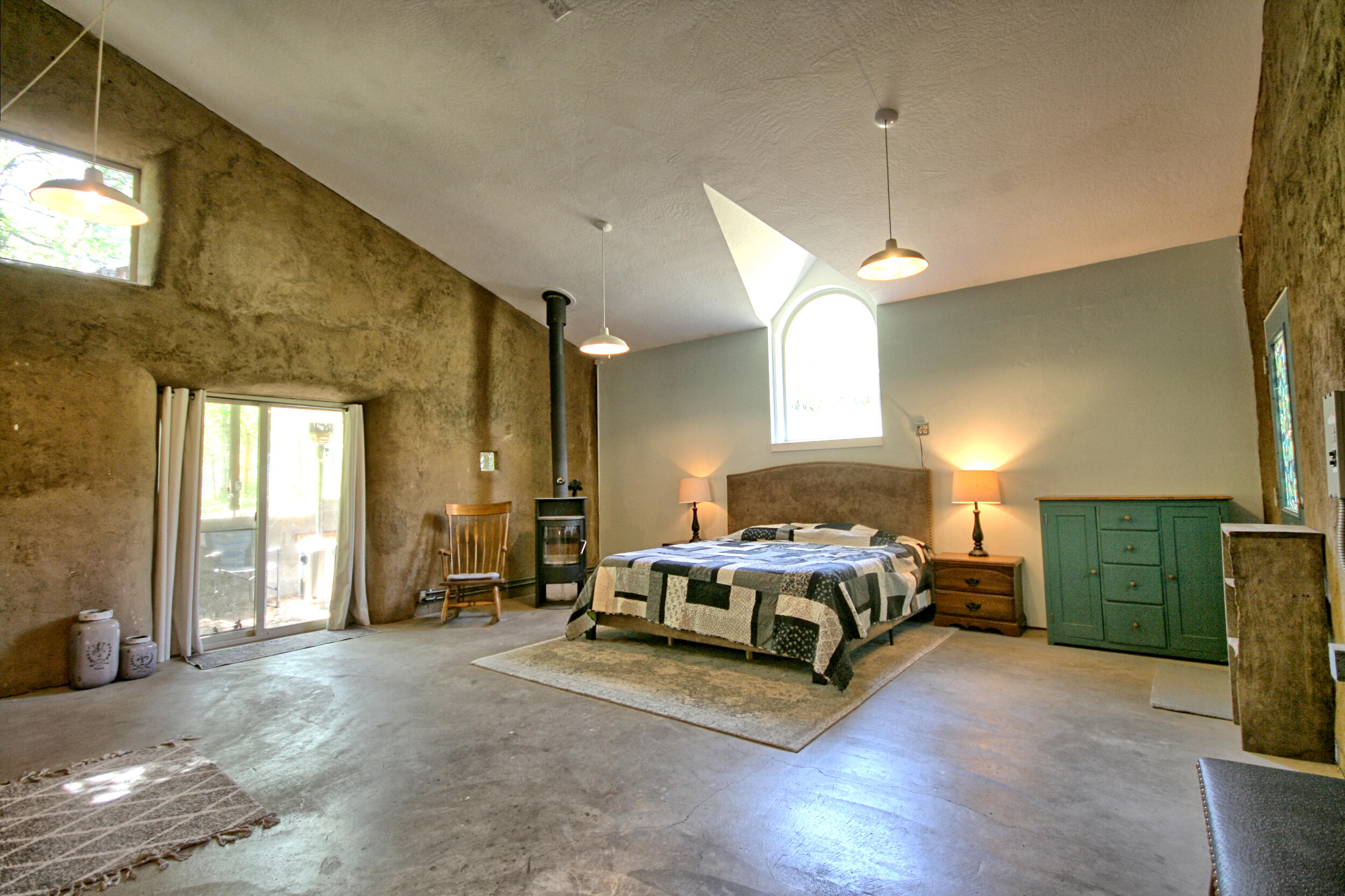 8150 Upper Applegate Road Jacksonville, OR 97530 - Photo 81 of 122 a spacious bedroom with a bed and a chandelier