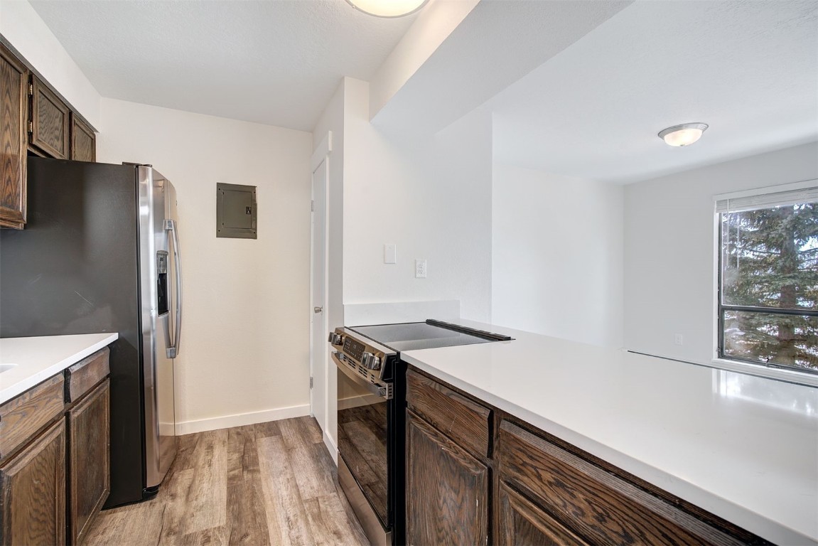 120 La Bonte Street, Unit 202 Dillon, CO 80435 - Photo 11 of 29 a view of a kitchen with a sink wooden cabinets and refrigerator