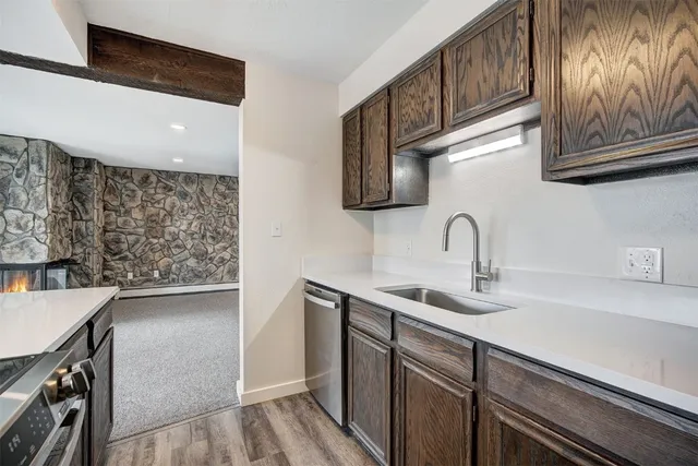 a kitchen with stainless steel appliances granite countertop a sink and a stove