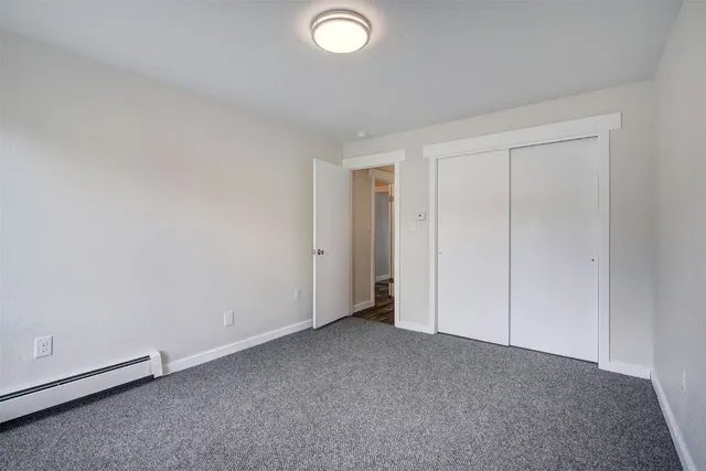 an empty room with closet area
