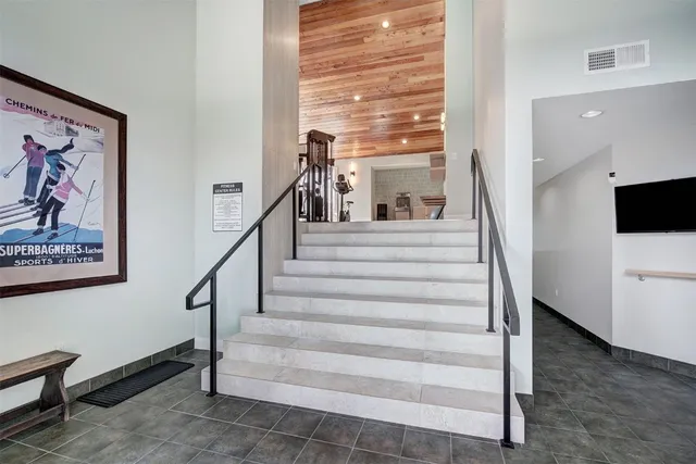 a view of staircase with white walls and a window