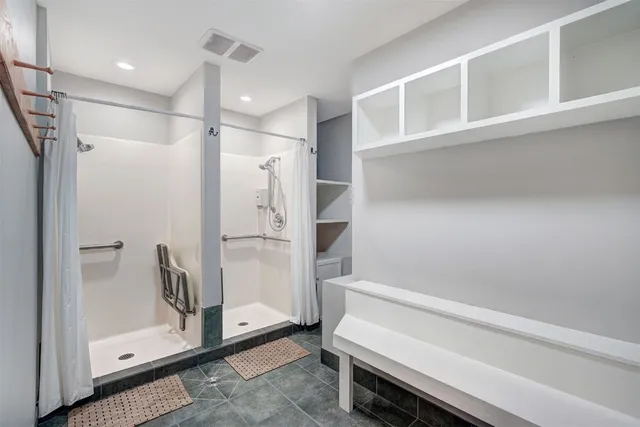 a bathroom with a shower and a glass door
