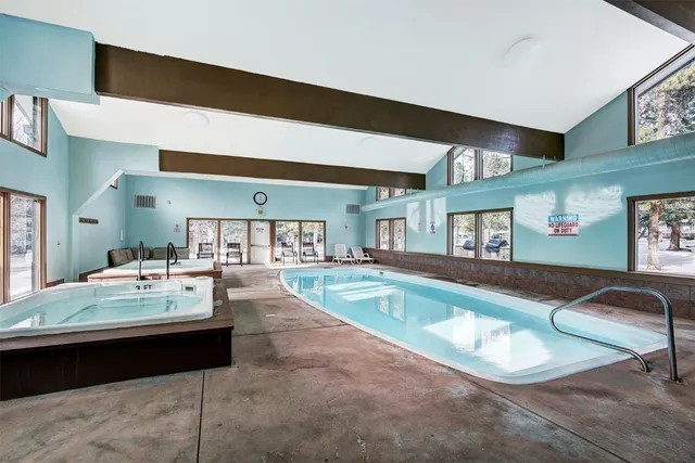 a living room with hard wood flooring and furniture