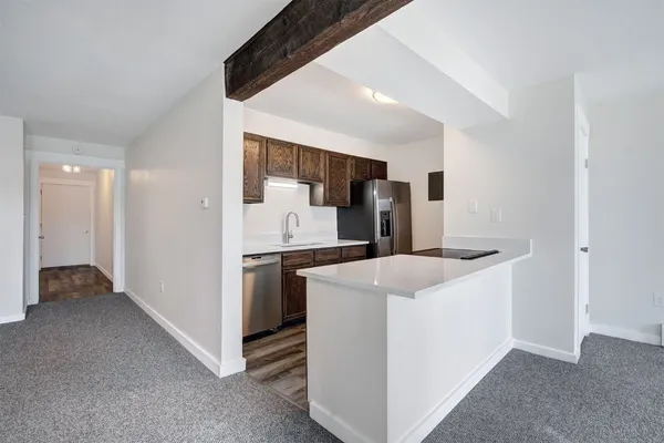a kitchen that has a sink and a stove in it