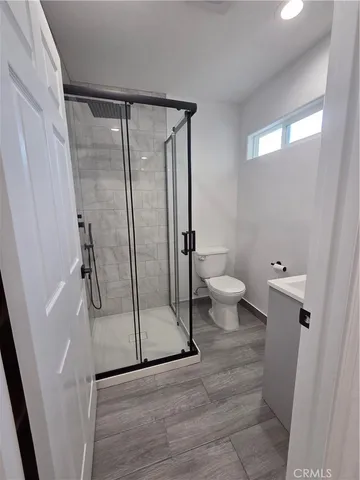 a bathroom with a toilet and a shower