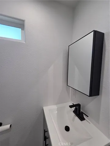 a bathroom with a sink and mirror