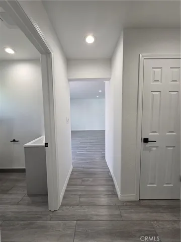 a view of a hallway with wooden floor