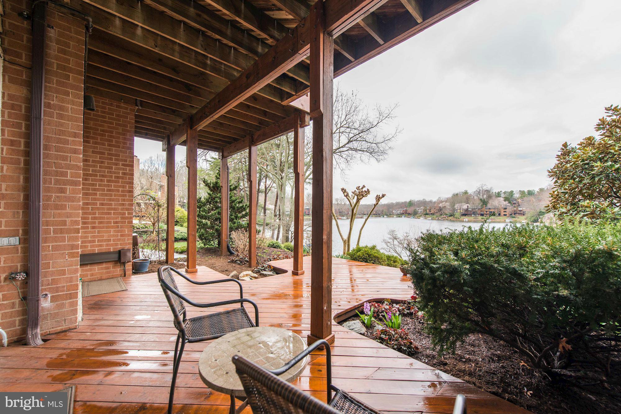 11076 Thrush Ridge Road Reston, VA 20191 - Photo 23 of 29 a view of a chairs and table in patio with wooden fence