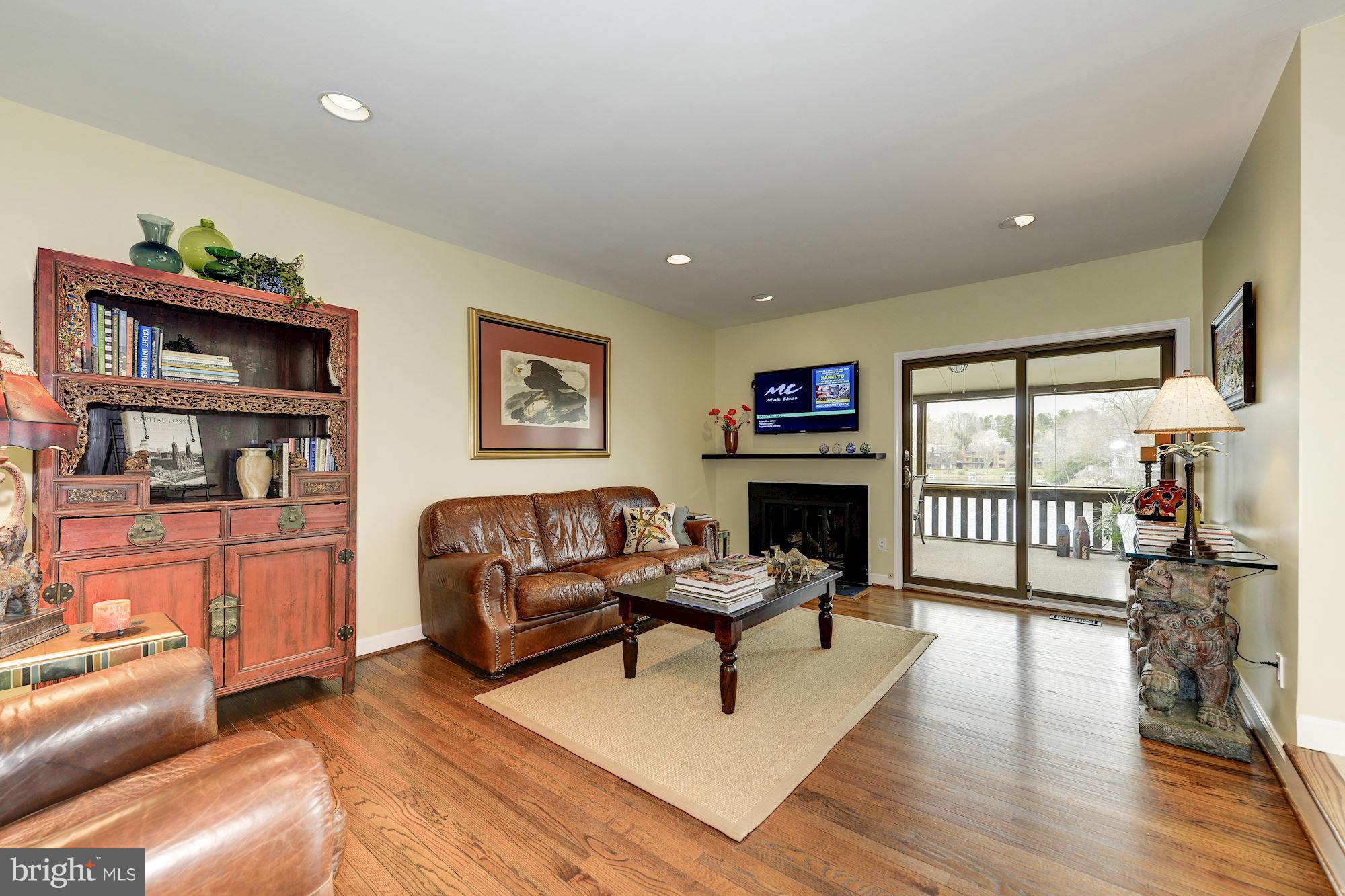 11076 Thrush Ridge Road Reston, VA 20191 - Photo 5 of 29 a living room with furniture a fireplace and a flat screen tv