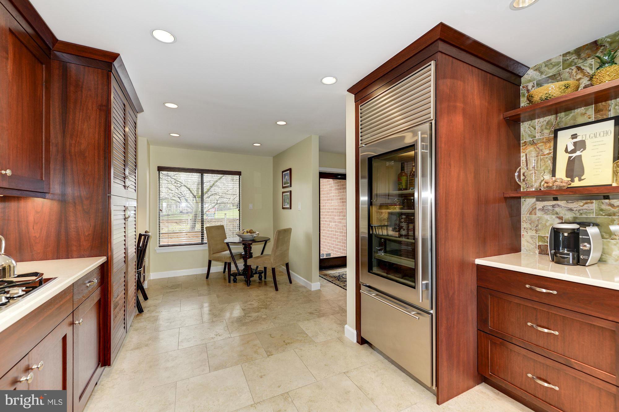 11076 Thrush Ridge Road Reston, VA 20191 - Photo 10 of 29 a view of kitchen with kitchen island granite countertop cabinets and dining table