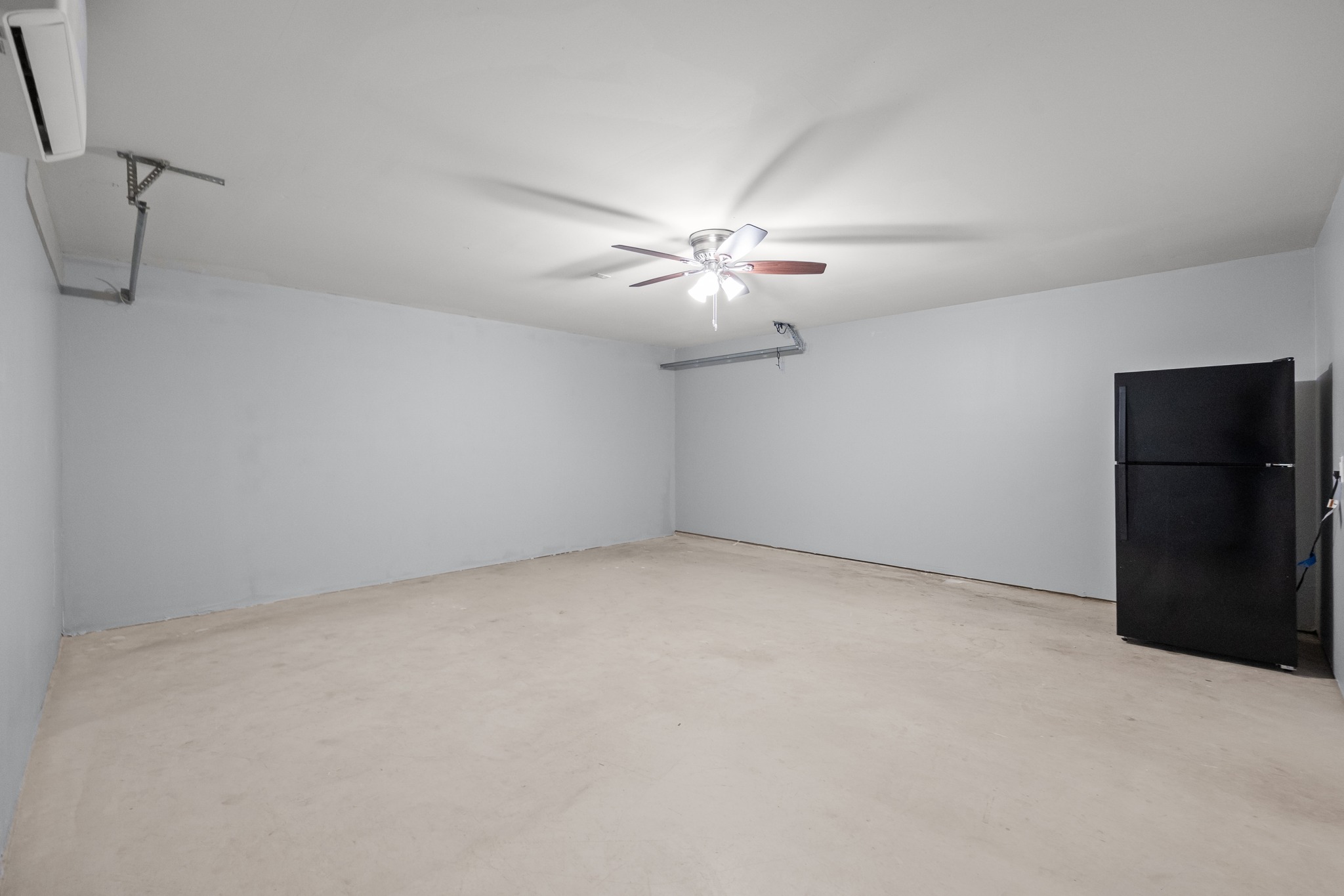 228 Millers Loop Jarrell, TX 76537 - Photo 19 of 26 An expansive garage structure features finished drywall and durable poured concrete flooring.