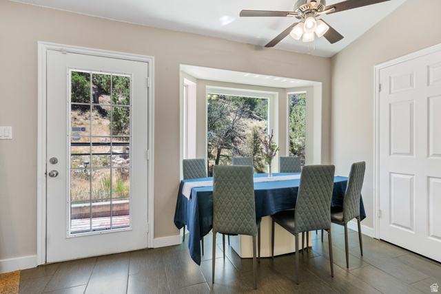 790 East Fiddlers Canyon Road Cedar City, UT 84721 - Photo 7 of 35 Dining area with wood-finish tile flooring, a multi-pane glass panel door, and a bay window