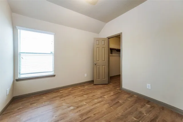 an empty room with window and closet
