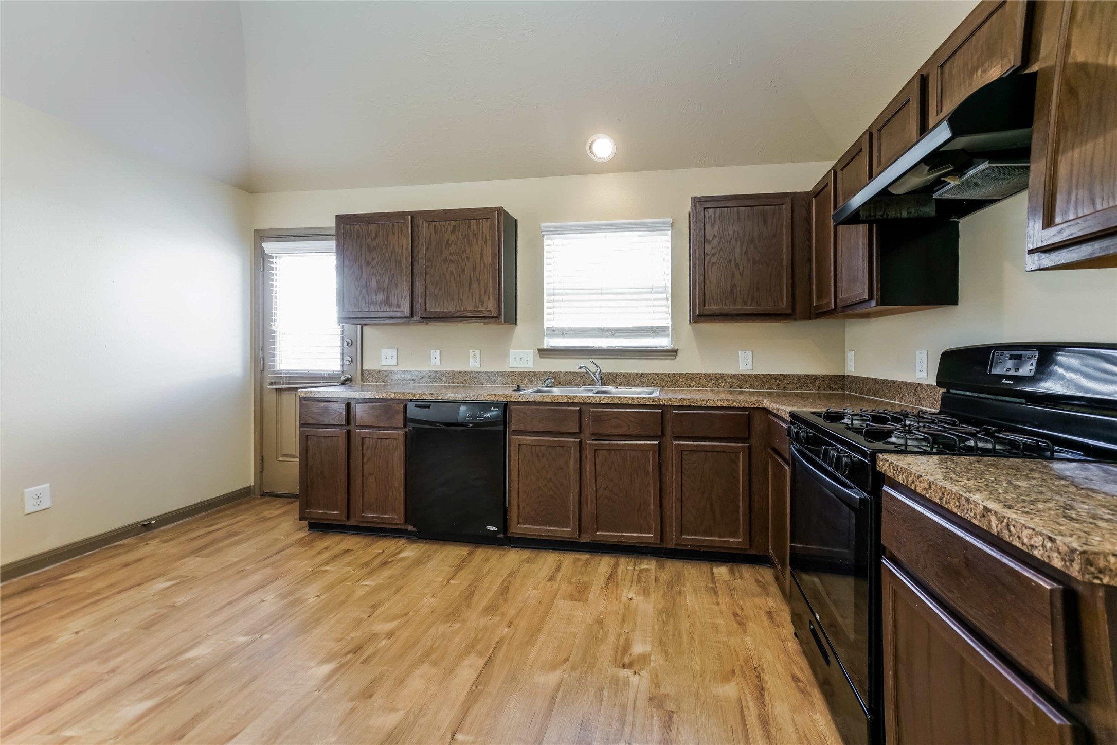 21811 South Werrington Way Houston, TX 77073 - Photo 2 of 13 a kitchen with stainless steel appliances granite countertop a stove a sink and a microwave