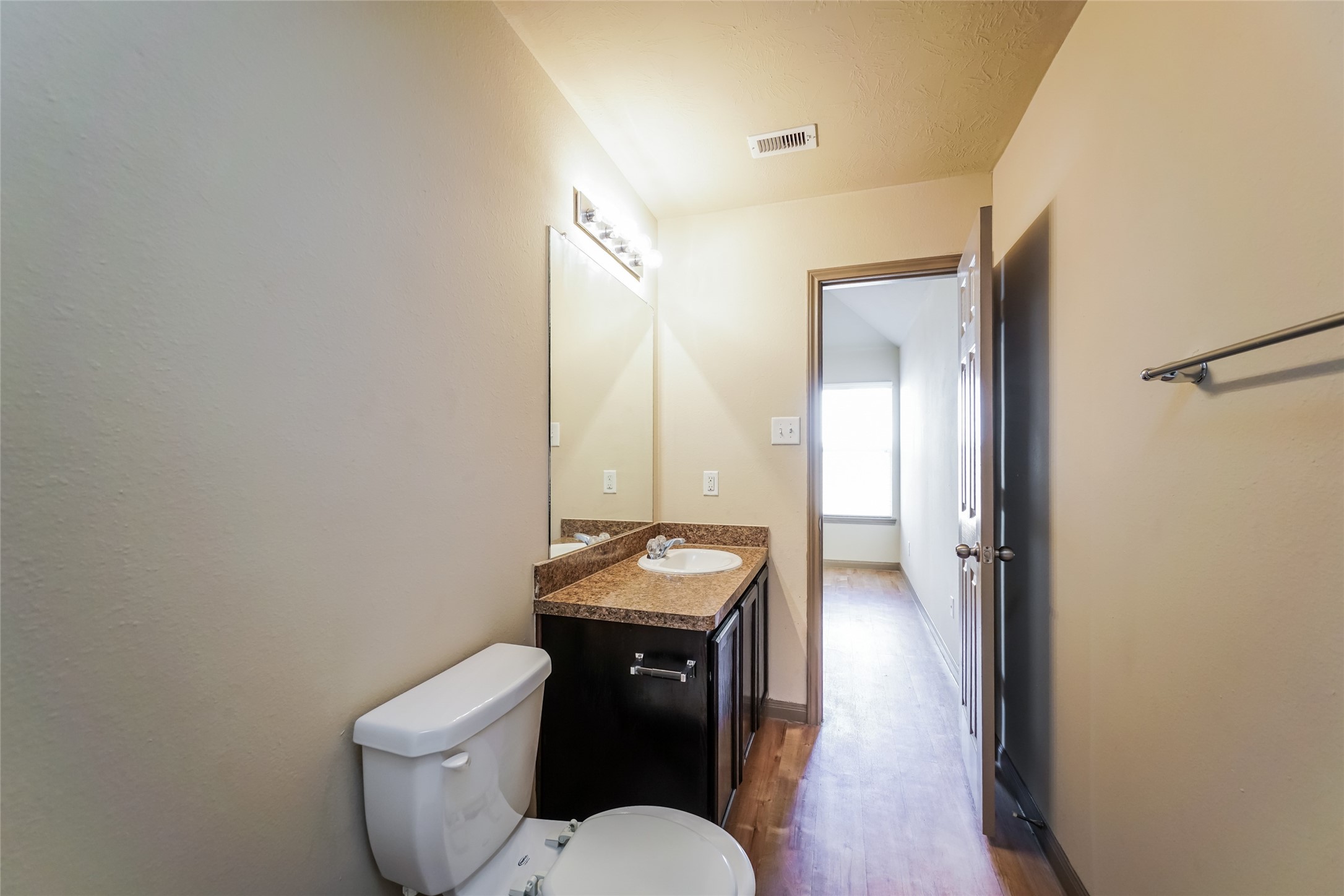 21811 South Werrington Way Houston, TX 77073 - Photo 9 of 13 a bathroom with a granite countertop toilet a sink and a mirror