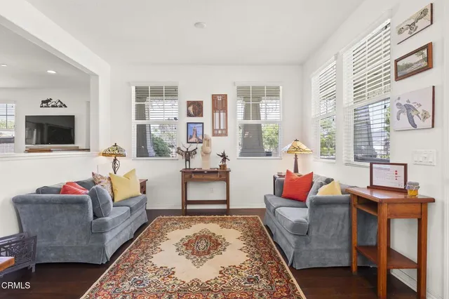 a living room with furniture wooden floor and a table
