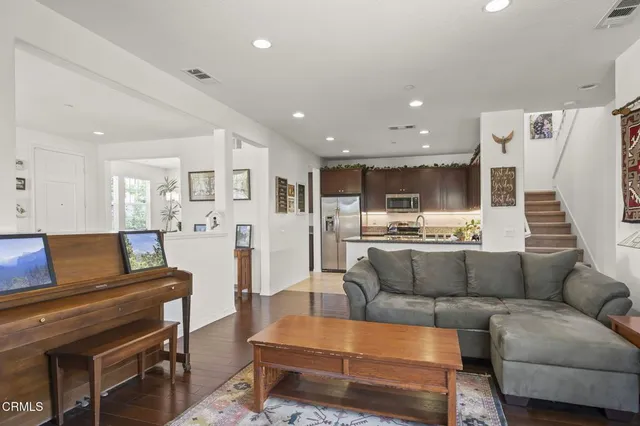 a kitchen with stainless steel appliances kitchen island granite countertop a refrigerator and a stove top oven