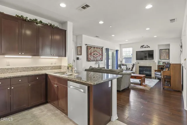 a bathroom with a granite countertop sink a mirror and shower