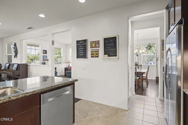 a kitchen with stainless steel appliances granite countertop a sink a oven and a refrigerator