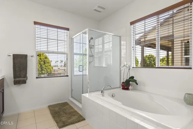 a spacious bathroom with a granite countertop sink mirror and a