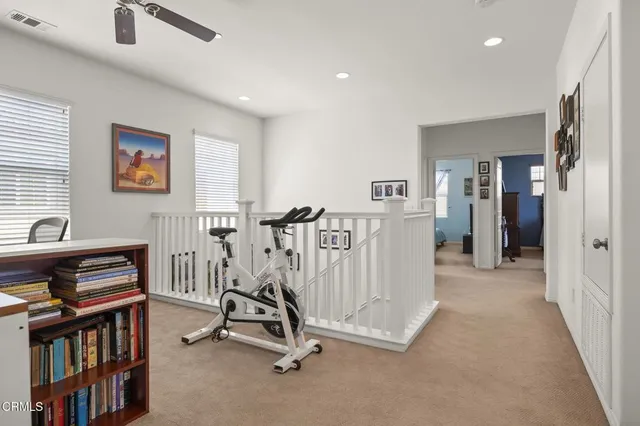 a view of a workspace with furniture and staircase