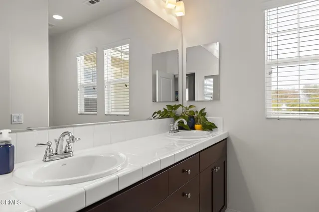 a bathroom with a sink double vanity and a mirror