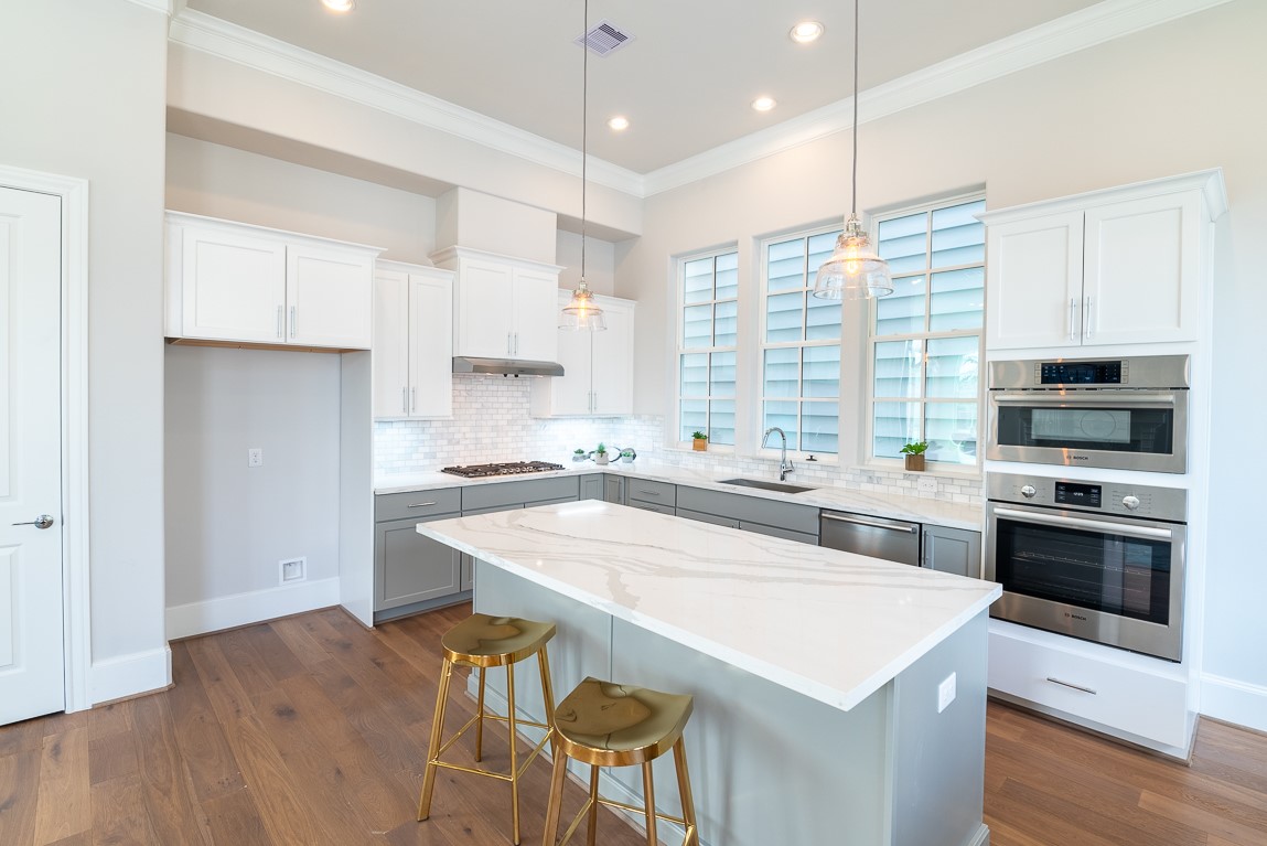 642 Delmar Street Houston, TX 77023 - Photo 10 of 23 a kitchen with stainless steel appliances a stove a sink a microwave a refrigerator and cabinets