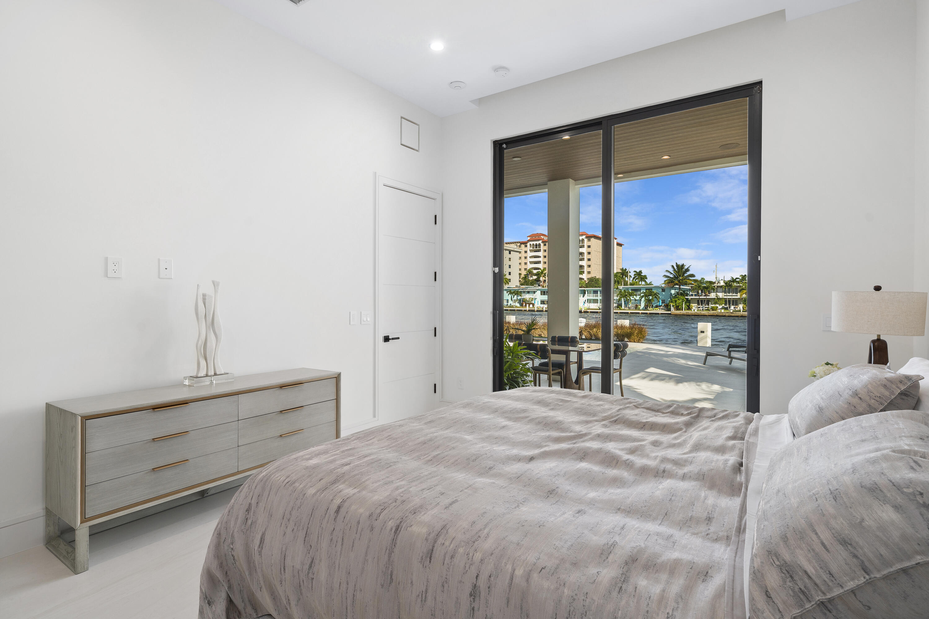 2880 Northeast 9th Street Pompano Beach, FL 33062 - Photo 26 of 61 a bedroom with a bed and a large window