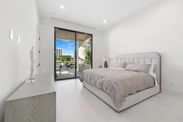 a spacious bedroom with a large bed and a window