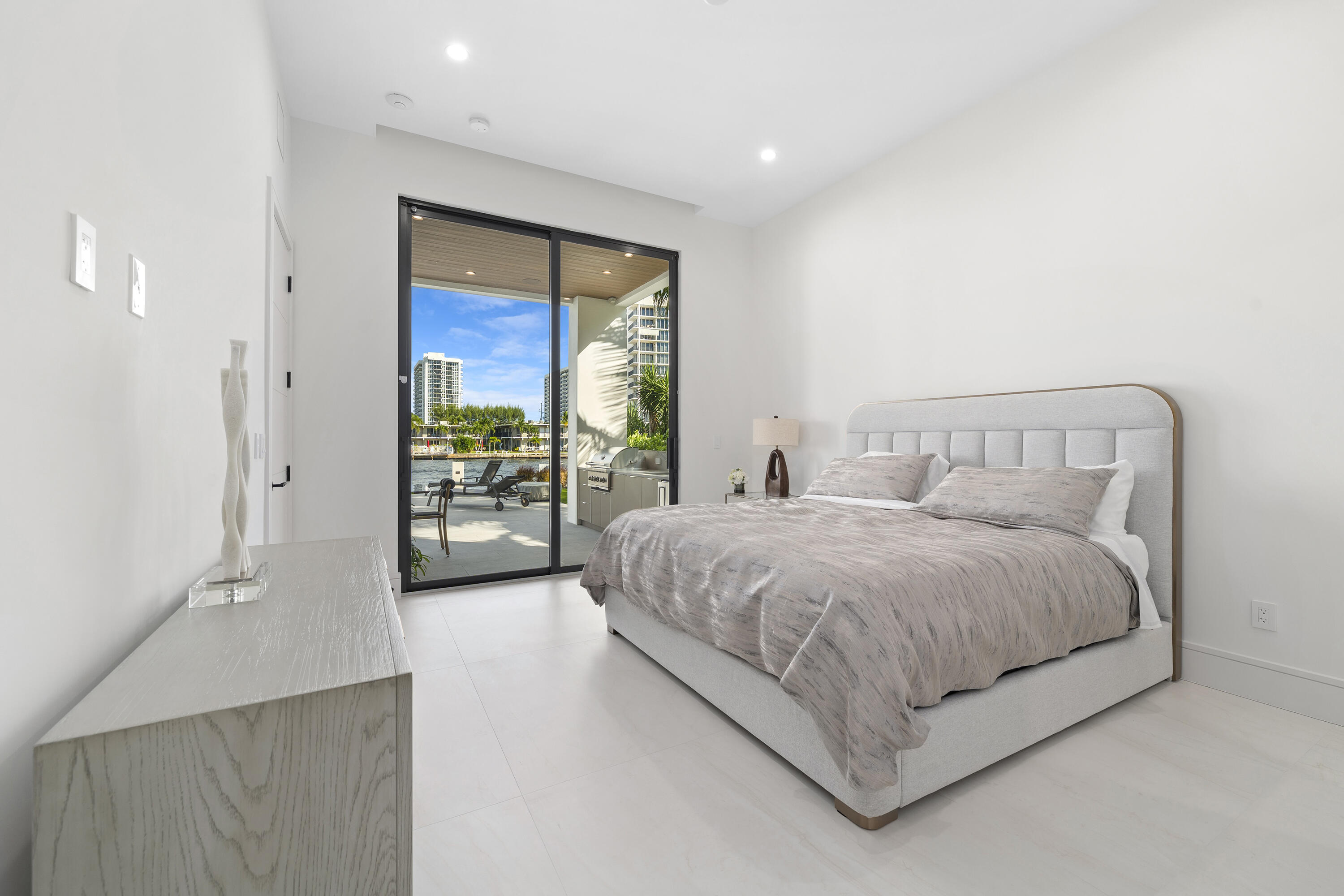 2880 Northeast 9th Street Pompano Beach, FL 33062 - Photo 27 of 61 a spacious bedroom with a large bed and a large window