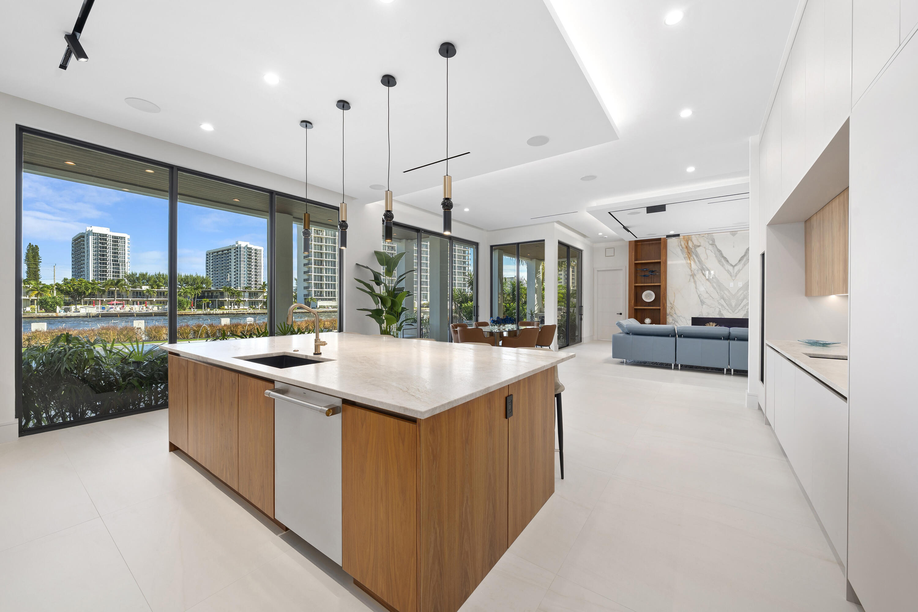 2880 Northeast 9th Street Pompano Beach, FL 33062 - Photo 32 of 61 a kitchen with stainless steel appliances granite countertop a kitchen island a stove a sink and a large window