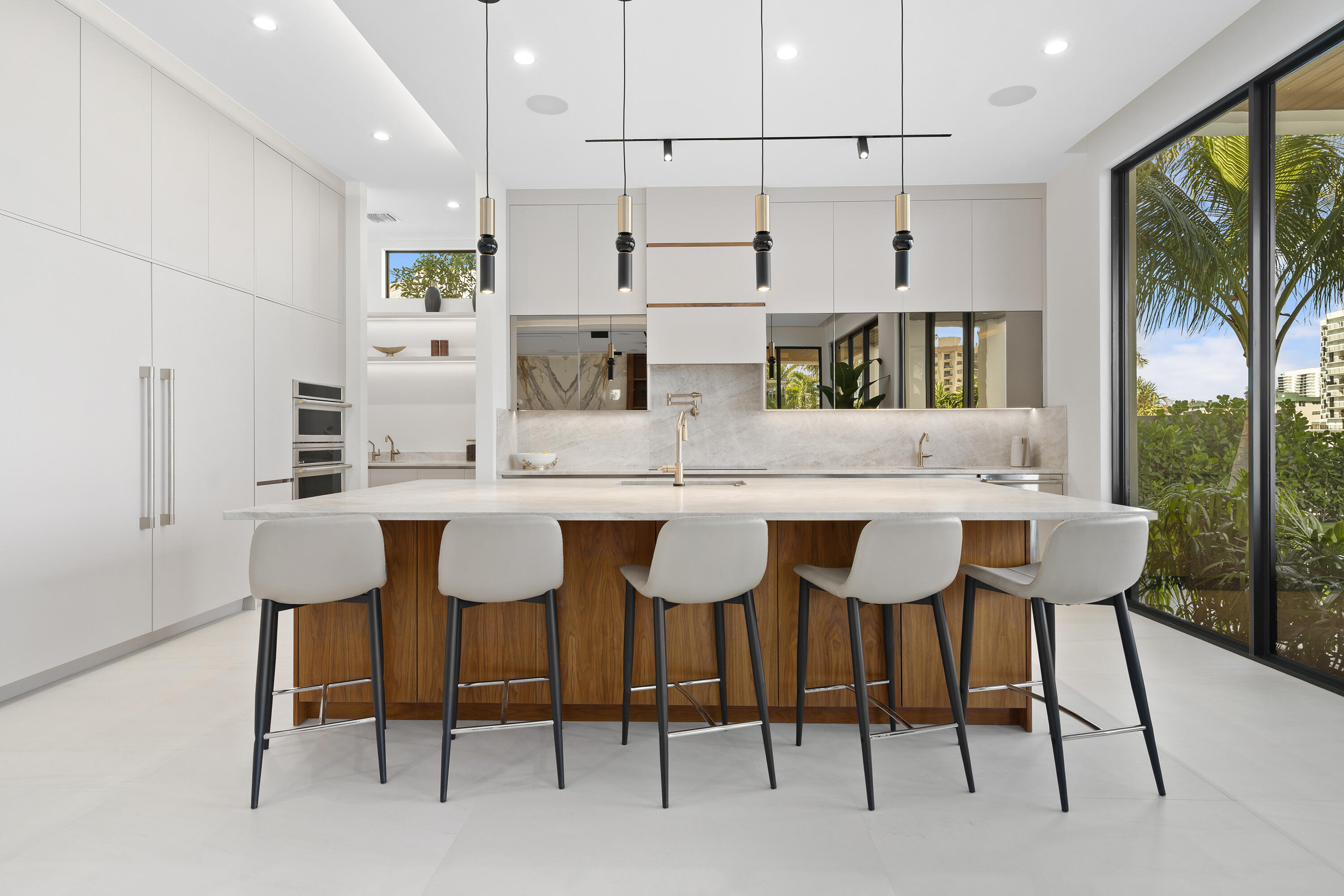 2880 Northeast 9th Street Pompano Beach, FL 33062 - Photo 37 of 61 a kitchen with stainless steel appliances kitchen island granite countertop a table and chairs in it