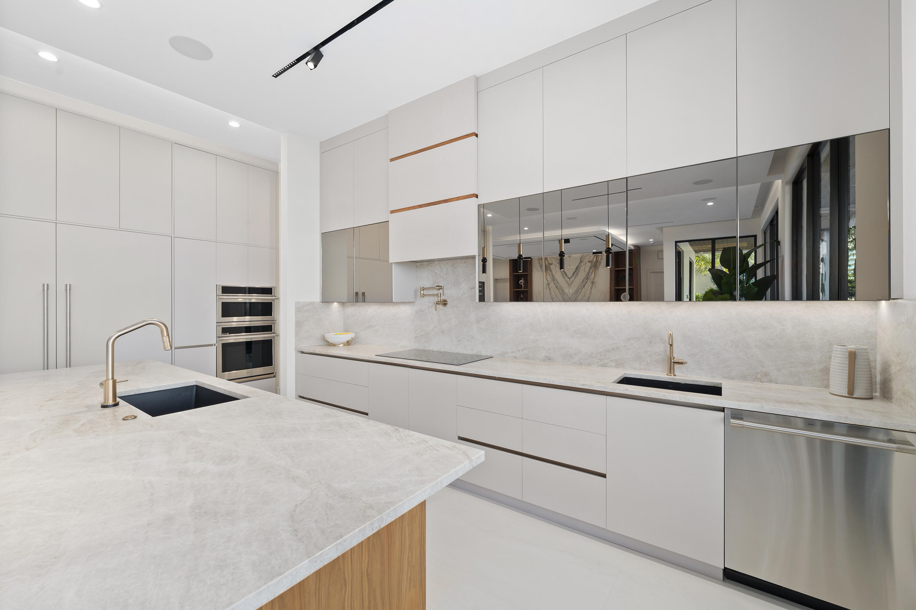 2880 Northeast 9th Street Pompano Beach, FL 33062 - Photo 39 of 61 a kitchen with stainless steel appliances a sink and a refrigerator