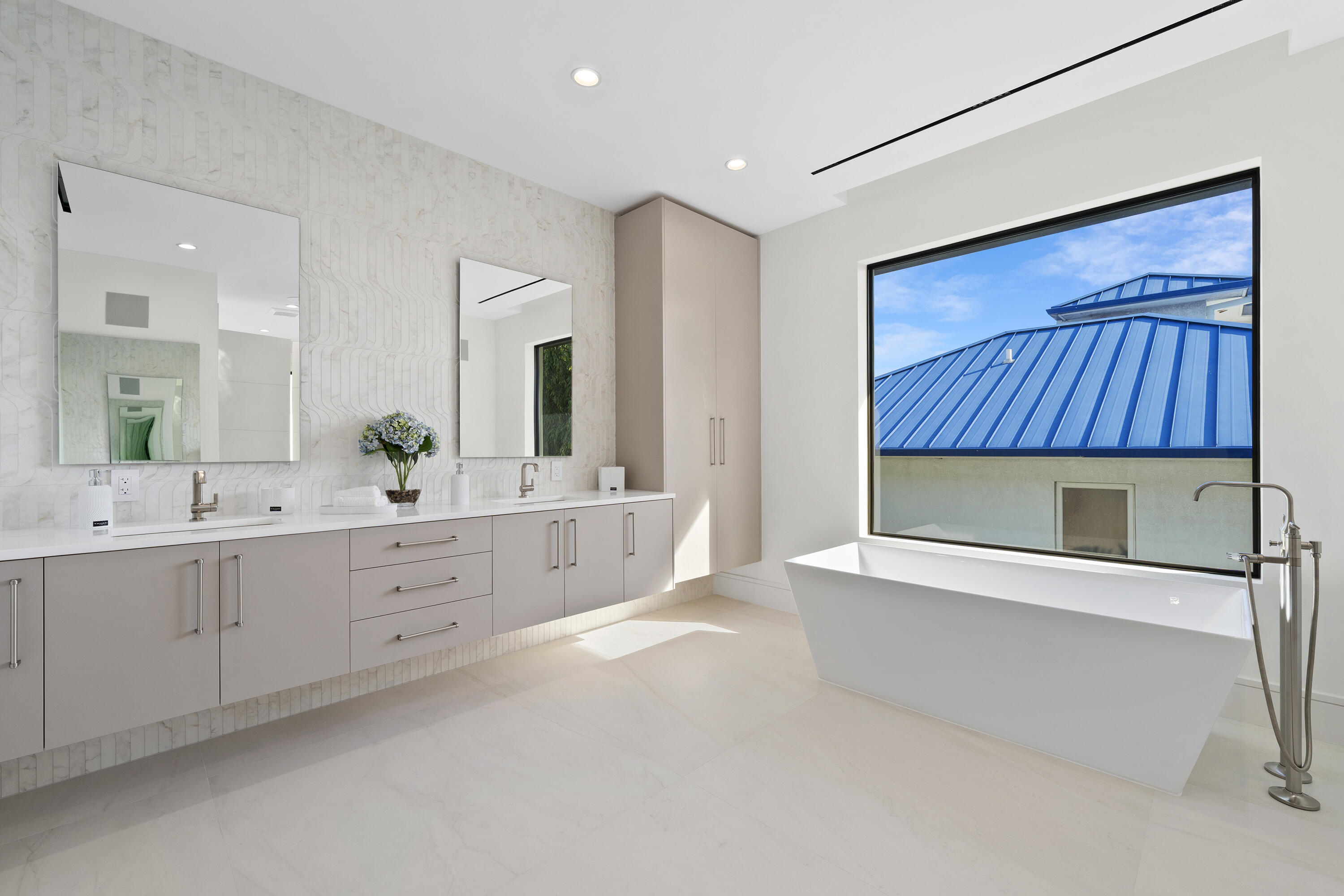 2880 Northeast 9th Street Pompano Beach, FL 33062 - Photo 55 of 61 a spacious bathroom with a double vanity sink and a mirror