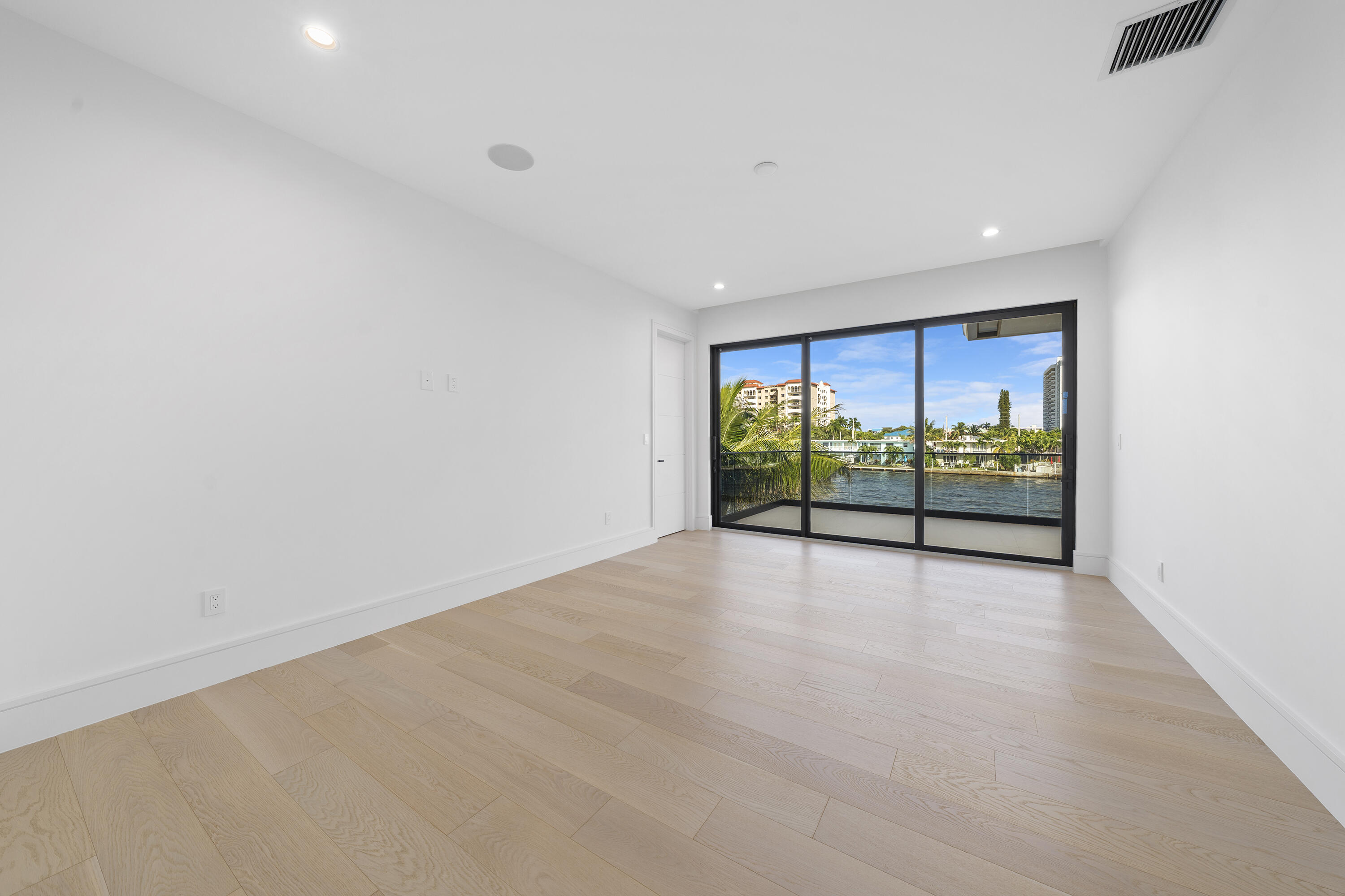 2880 Northeast 9th Street Pompano Beach, FL 33062 - Photo 56 of 61 a view of an empty room with wooden floor and outer view