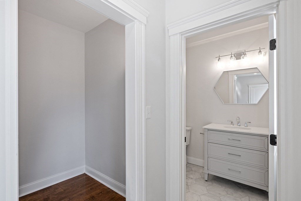 21 Alpha Road, Unit 1 Boston, MA 02124 - Photo 12 of 24 a bathroom with a sink a light fixture and a mirror