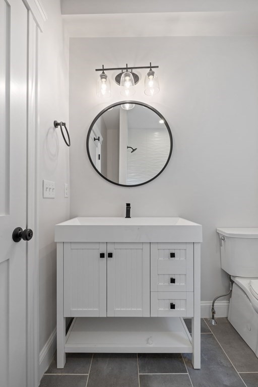21 Alpha Road, Unit 1 Boston, MA 02124 - Photo 21 of 24 a bathroom with a sink a mirror and shower