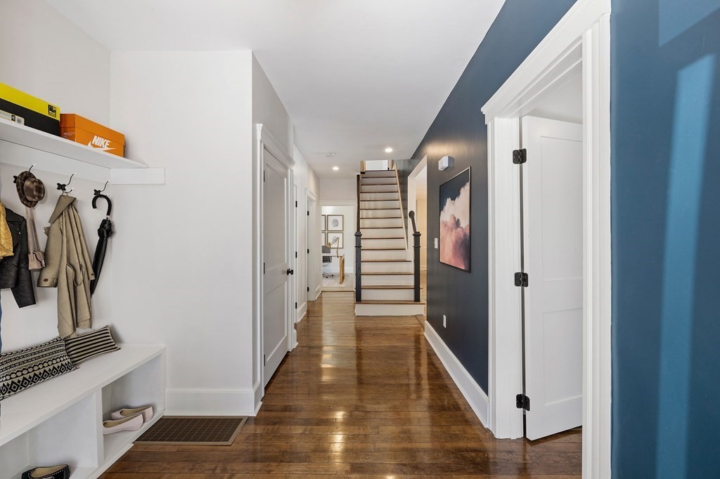 21 Alpha Road, Unit 1 Boston, MA 02124 - Photo 3 of 24 a view of a hallway with wooden floor and stairs