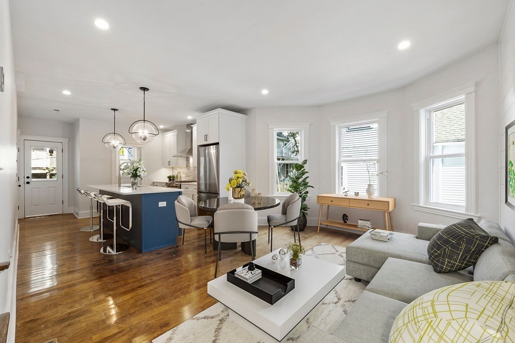 21 Alpha Road, Unit 1 Boston, MA 02124 - Photo 4 of 24 a living room with furniture kitchen and a large window