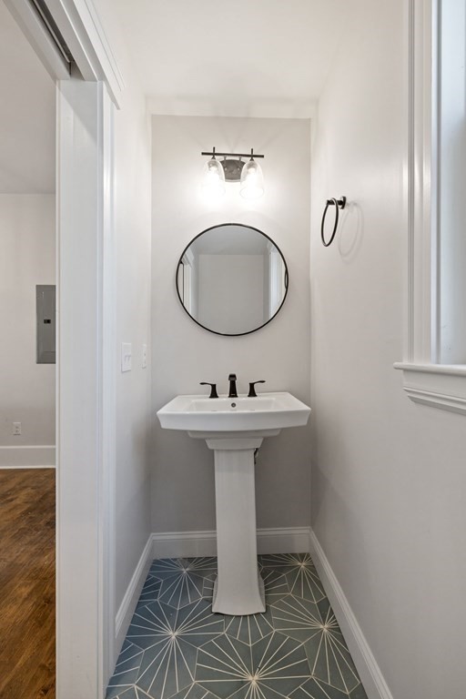 21 Alpha Road, Unit 1 Boston, MA 02124 - Photo 8 of 24 a bathroom with a sink a toilet and mirror
