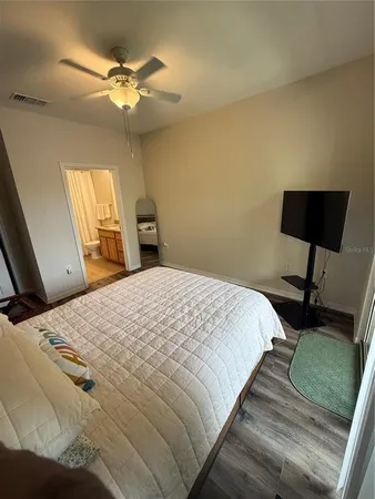 a bedroom with a bed and a chandelier