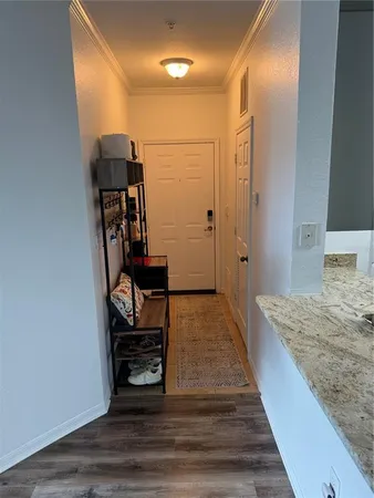 a view of a hallway with wooden floor and staircase