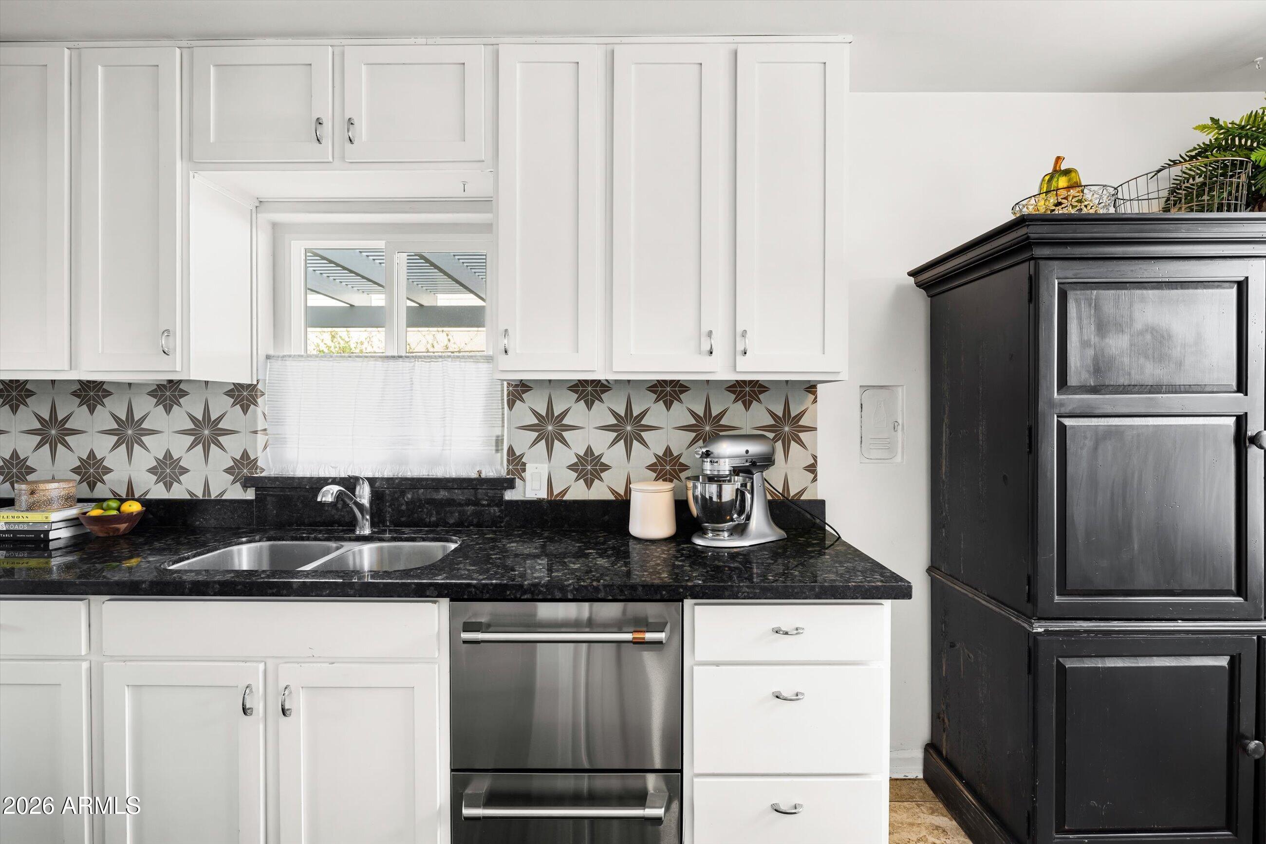 537 Virginia Avenue Phoenix, AZ 85003 - Photo 11 of 32 a kitchen with stainless steel appliances granite countertop a refrigerator sink and white cabinets